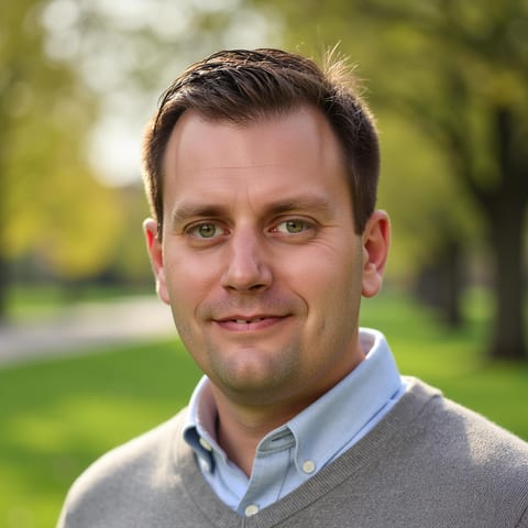 Zack Pearson, founder of Pro Build Digital, smiling outdoors in a gray sweater